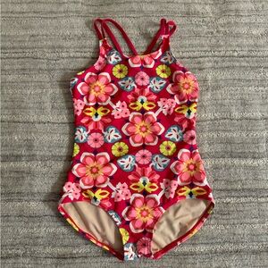 Brand new. Never worn. Tea brand cross back girls onepieceswimsuit. Size 12.